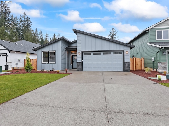 view of front of property featuring a garage and a front lawn