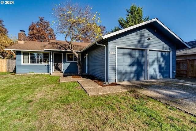 view of front of property with a garage and a front yard