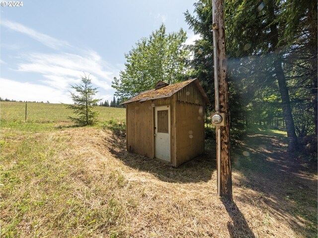 view of outdoor structure with a rural view