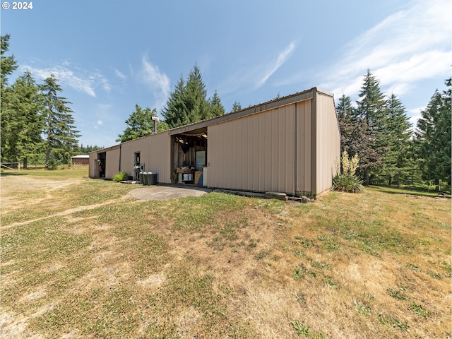 view of outbuilding with a lawn