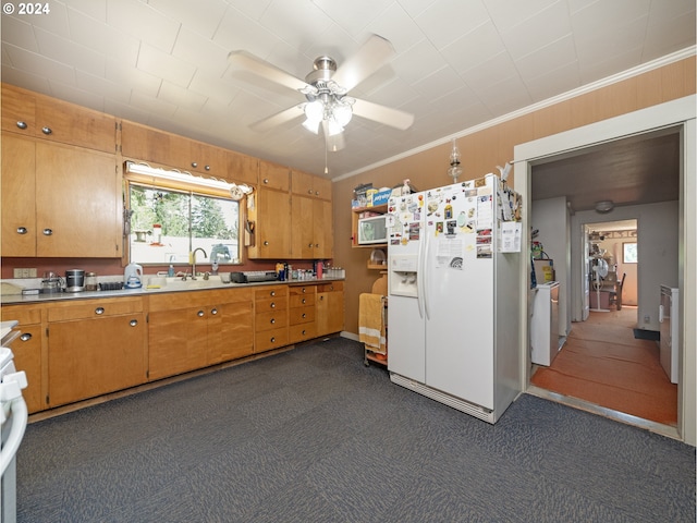 kitchen featuring white fridge with ice dispenser, sink, ornamental molding, ceiling fan, and dark carpet