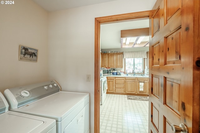 washroom with separate washer and dryer and sink