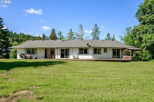 rear view of property with a yard