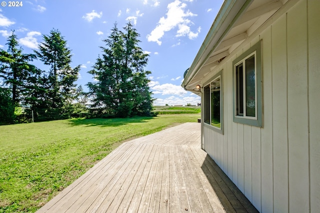 wooden terrace with a lawn