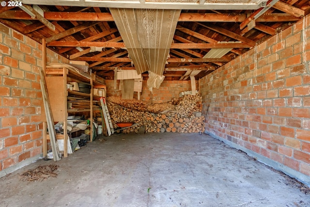 interior space with concrete flooring and brick wall