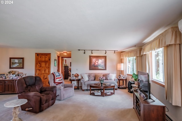 carpeted living room featuring rail lighting and a baseboard radiator