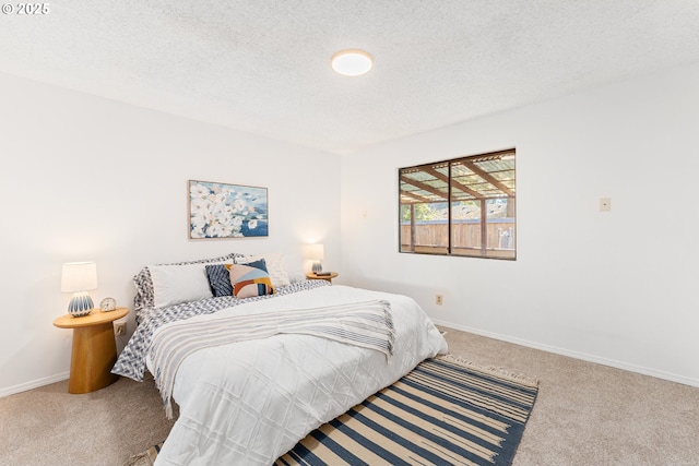 bedroom featuring carpet floors and a textured ceiling