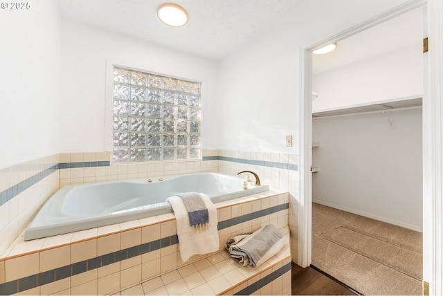 bathroom featuring tiled tub