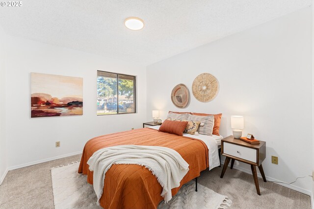 carpeted bedroom featuring a textured ceiling