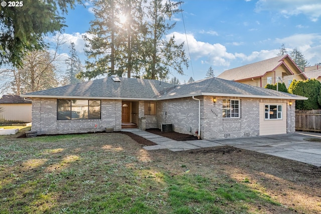 rear view of property featuring a lawn and central air condition unit