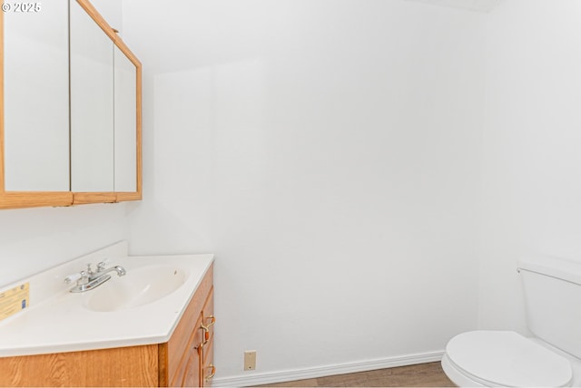 bathroom featuring hardwood / wood-style flooring, vanity, and toilet