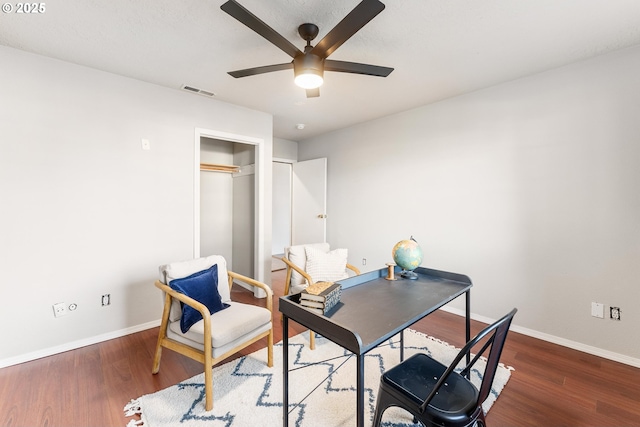 office area with dark wood-type flooring and ceiling fan