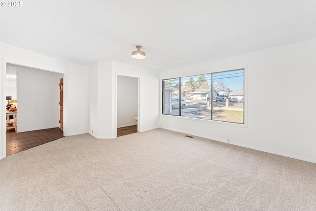 unfurnished room featuring carpet