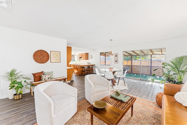 living room with hardwood / wood-style flooring, a textured ceiling, and a healthy amount of sunlight