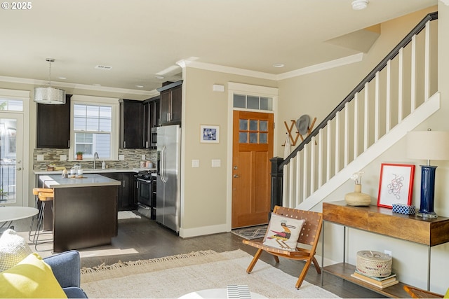 3050 SE 50th Ave Unit 6, Portland, OR 97206 - kitchen featuring appliances with stainless steel finishes, a sink, light countertops, dark wood finished floors, and a center island