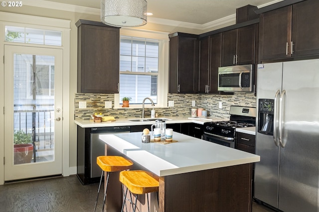3050 SE 50th Ave Unit 6, Portland, OR 97206 - kitchen with stainless steel appliances, a sink, crown molding, light countertops, and backsplash