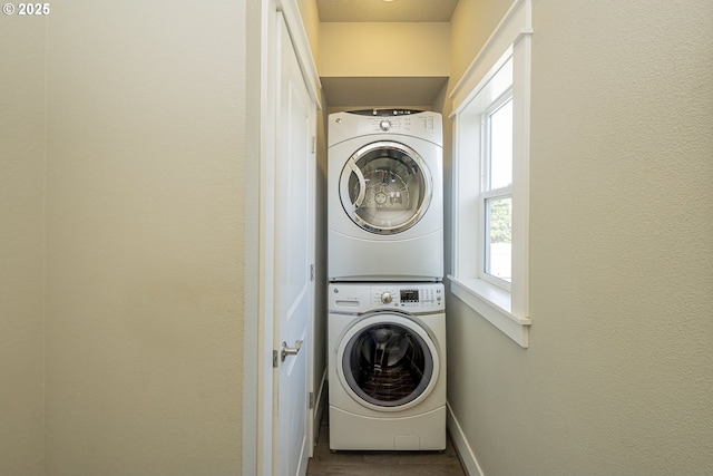 3050 SE 50th Ave Unit 6, Portland, OR 97206 - laundry area featuring stacked washer and clothes dryer, baseboards, plenty of natural light, and dark wood-style flooring
