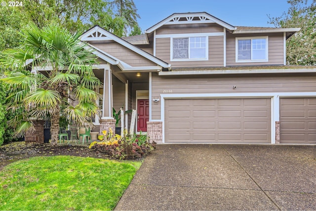 craftsman inspired home with concrete driveway, a garage, and a shingled roof