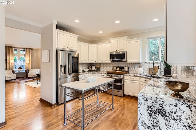 20160 SW 58th Ter, Tualatin, OR 97062 - living area featuring visible vents, ornamental molding, a tiled fireplace, and light wood-type flooring