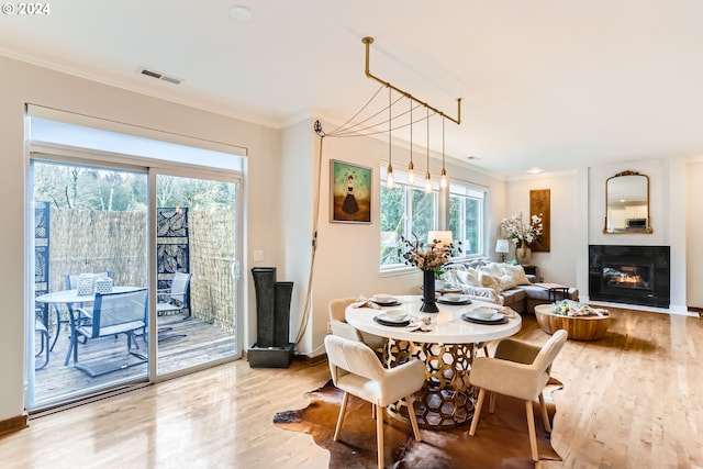 20160 SW 58th Ter, Tualatin, OR 97062 - dining area featuring ornamental molding, visible vents, a wealth of natural light, and wood finished floors