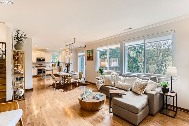 20160 SW 58th Ter, Tualatin, OR 97062 - living room with visible vents, crown molding, baseboards, recessed lighting, and light wood-style flooring