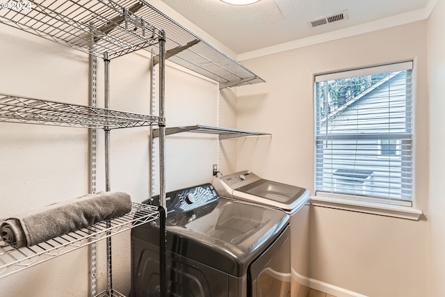20160 SW 58th Ter, Tualatin, OR 97062 - clothes washing area featuring washing machine and clothes dryer, laundry area, baseboards, visible vents, and ornamental molding
