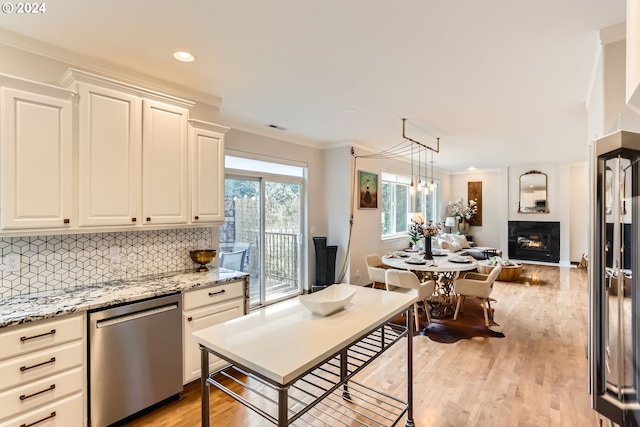 20160 SW 58th Ter, Tualatin, OR 97062 - kitchen with stainless steel dishwasher, open floor plan, light wood-type flooring, white cabinets, and backsplash