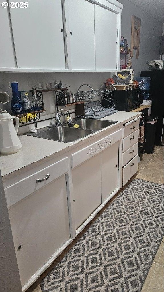 414 SE 17th St, Pendleton, OR 97801 - kitchen featuring white cabinetry, light countertops, and light tile patterned floors