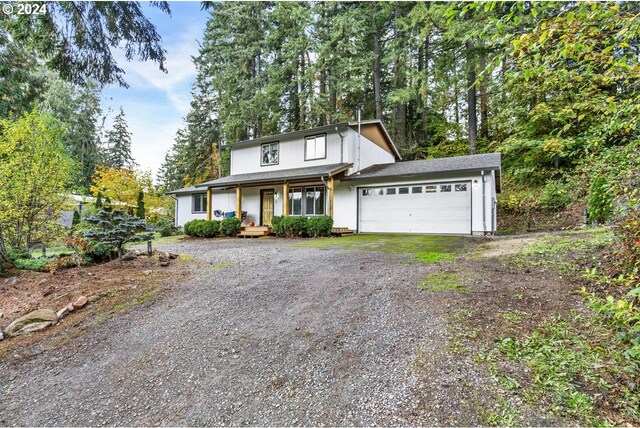 19500 S Rockie Dr, Mulino, OR 97042 - traditional-style home with a porch, dirt driveway, and a garage
