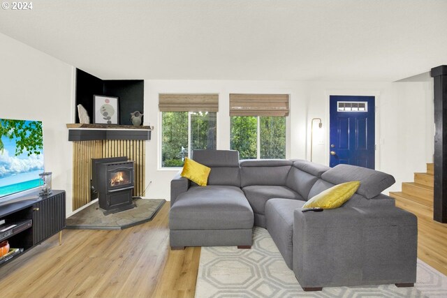 19500 S Rockie Dr, Mulino, OR 97042 - living room with wood finished floors, a wood stove, and stairs