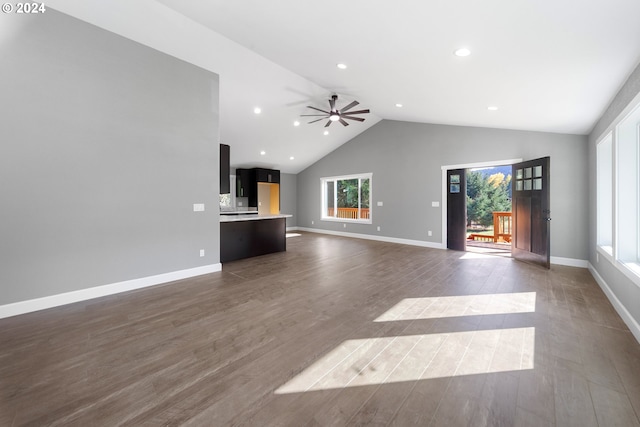 unfurnished living room featuring lofted ceiling, dark wood-type flooring, and ceiling fan