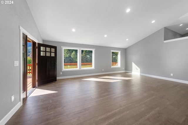 interior space with high vaulted ceiling and dark hardwood / wood-style flooring