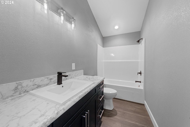 full bathroom with toilet, hardwood / wood-style floors, vanity, and  shower combination