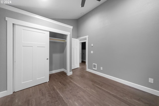 unfurnished bedroom with dark wood-type flooring, high vaulted ceiling, a closet, and ceiling fan