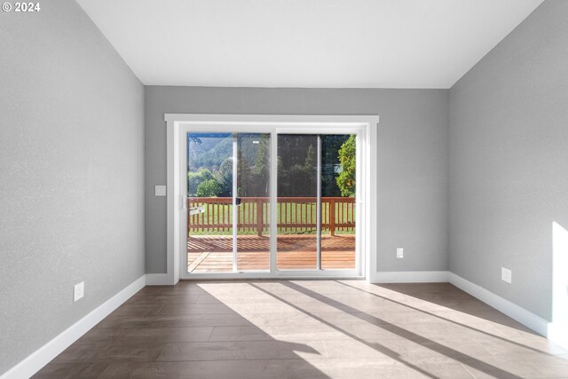 unfurnished room with hardwood / wood-style floors