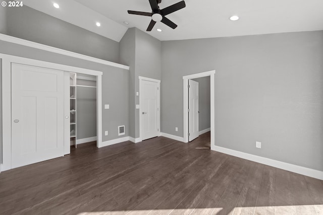 unfurnished bedroom featuring a closet, dark hardwood / wood-style floors, high vaulted ceiling, and ceiling fan