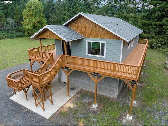 exterior space with a wooden deck, a front yard, and a patio area