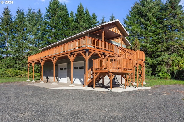 log-style house featuring a wooden deck and a garage