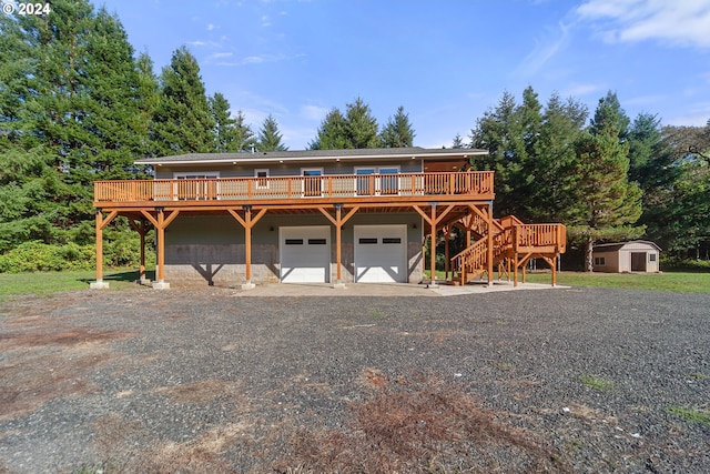 view of front facade featuring a wooden deck and a shed