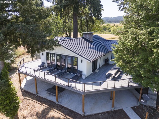 back of property with a deck and french doors