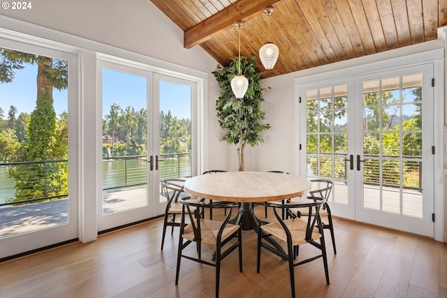 dining space with wooden ceiling, lofted ceiling with beams, french doors, and light wood-type flooring