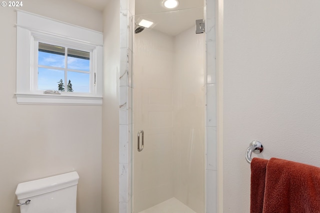 bathroom featuring toilet and walk in shower