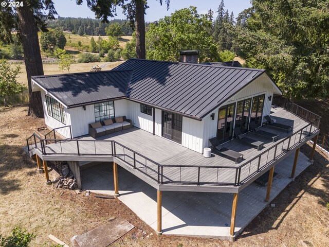 rear view of property featuring a deck