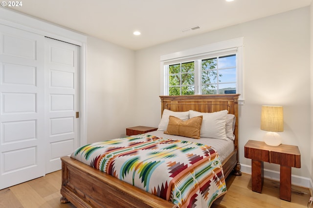 bedroom featuring light wood-type flooring and a closet