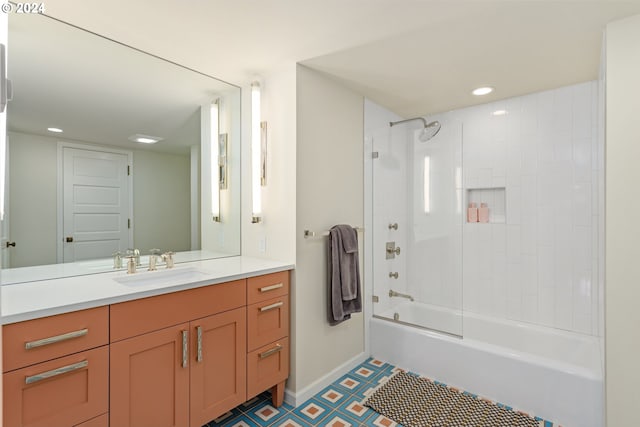 bathroom with tiled shower / bath combo and vanity