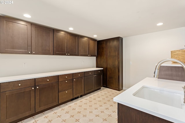 kitchen featuring sink and dark brown cabinets