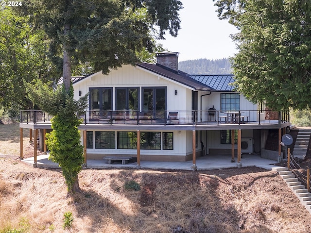 back of property with a patio and a deck