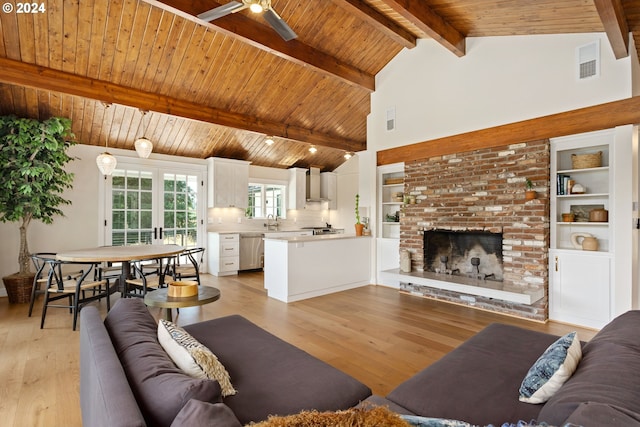 living room featuring wooden ceiling, light wood-type flooring, lofted ceiling with beams, and a brick fireplace