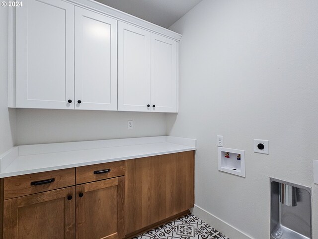 laundry area featuring cabinets, hookup for an electric dryer, and hookup for a washing machine