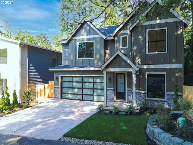 craftsman house with a garage and a front lawn